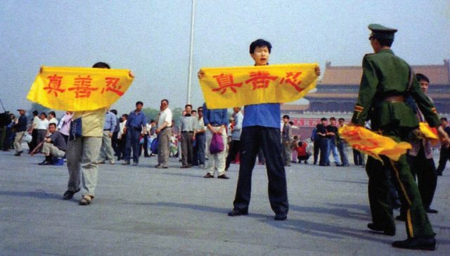Falun Gong practitioners raise banners reading Truth, Compassion, Forbearance as police approach on Tiananmen Square 