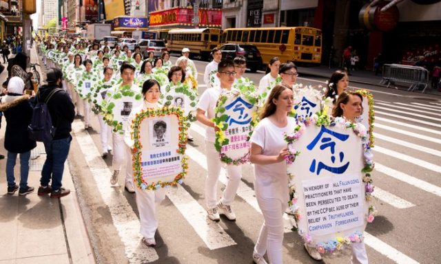 Falun Gong practitioners hold wreaths with photos of people who were killed in China for their beliefs, at a parade along 42nd Street in New York City on May 12, 2017. (Samira Bouaou/The Epoch Times)