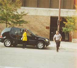 Photo taken by Bill Fang moments before he was attacked. The attacker, Mr. Zheng, is shown crossing the street towards Mr. Fang as his accomplice, Mr. Weng, emerges from the backseat of the car.