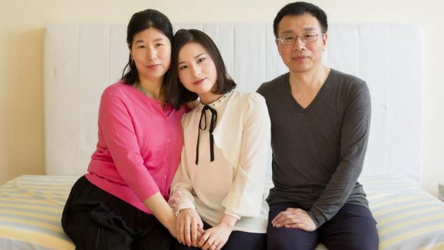 Ms. Wang Huijuan, Li Fuyao, and Mr. Li Zhenjun at their home in Queens, New York, on Jan. 8, 2017. The family escaped China in 2014 and were granted asylum after enduring years of torture for practicing Falun Gong.
