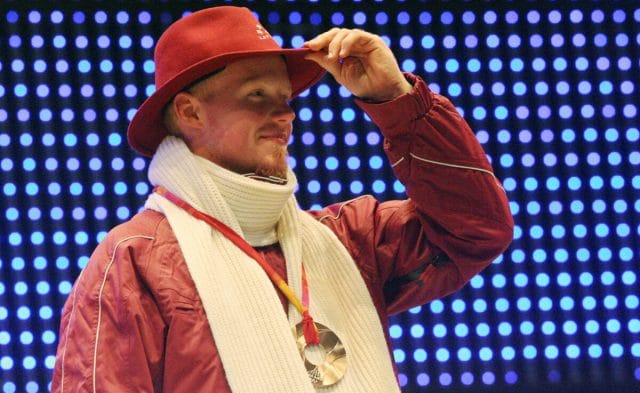 Turin, ITALY:  Bronze medallist Latvia's Martins Rubenis celebrates during a 2006 Winter Olympics medal ceremony in Turin, 13 February 2006 a day after the singles luge final. (Photo credit:  THOMAS COEX/AFP via Getty Images)