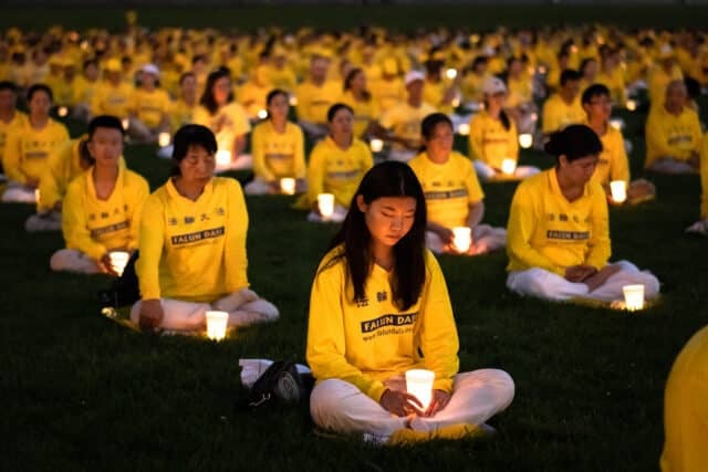 Over a thousand Falun Gong practitioners hold a candlelight vigil at the Washington Monument on July 21, 2022. (Samira Bouaou/The Epoch Times)