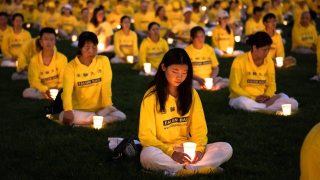 Over a thousand Falun Gong practitioners hold a candlelight vigil at the Washington Monument on July 21, 2022. (Samira Bouaou/The Epoch Times)