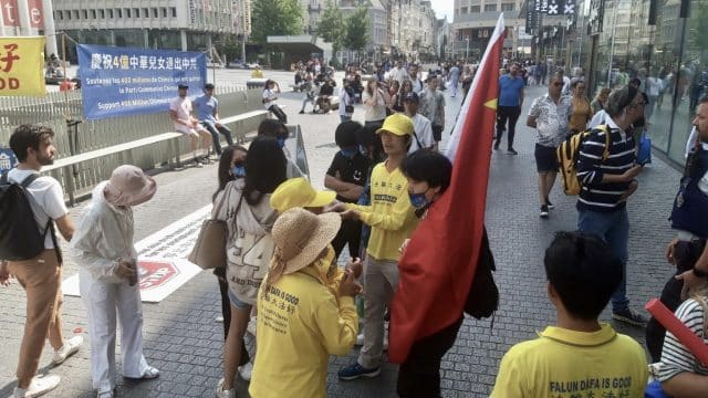 Multiple pro-CCP activists with masks and one with a shirt reading “China” disrupted a Falun Gong appeal in Brussels, Belgium on July 26, 2023. One carried a large communist Chinese flag.