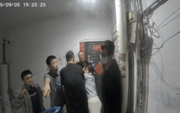 Doorbell footage shows Chen Zhongli (陈忠丽), an elderly mother in Shanxi, surrounded by multiple plainclothes officers moments before they break into her front door.