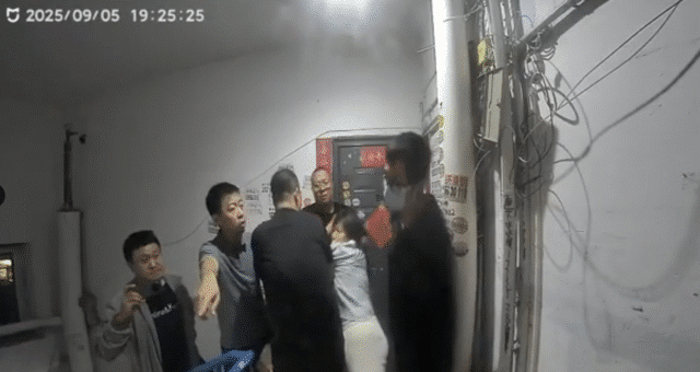 Doorbell footage shows Chen Zhongli (陈忠丽), an elderly mother in Shanxi, surrounded by multiple plainclothes officers moments before they break into her front door.