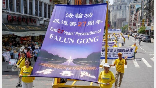 Falun Gong practitioners parade in Chinatown, Manhattan, New York on July 19, 2026. (Jingyi Zhang/Epoch Times)